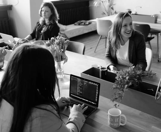 Three
          Ladies Working and Drinking Coffee on the Table